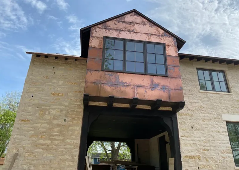 Copper metal panel facade on a stone building for Skylight Installation in North Fond du Lac